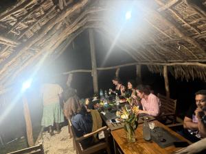 a group of people sitting at a table in a restaurant at Fireworks Tree House in White Sands