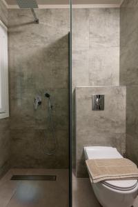 a bathroom with a shower with a toilet in it at Olea Mare Suites in Koinyra +56 photos