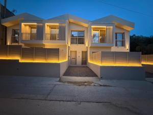 a building with lights on the front of it at LaK Private Pool Suites in Potos,Thassos in Potos