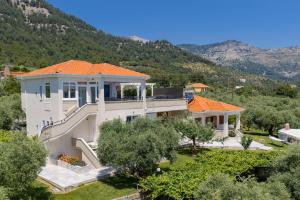 an aerial view of a house with a mountain at Olea Mare Suites in Koinyra