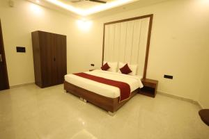 a bedroom with a large bed in a room at L Roy in Meerut
