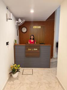 a woman standing behind a counter in an office at L Roy in Meerut