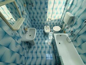 a bathroom with a toilet and a sink and a urinal at Villa Four-bedroom Prcan Kotor in Prčanj