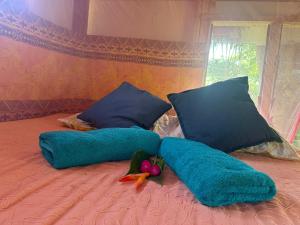 a bed with blue pillows and vegetables on it at Fireworks Tree House in White Sands +31 photos