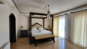 a bedroom with a bed and a bench in it at Villa Tiara by HolidayKeys in Kyrenia +23 photos