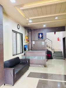 a living room with a couch and a staircase at Sun N Shine in Pune