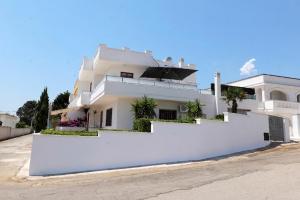 a white house with a white wall at cmv Salento in Marina di Pescoluse