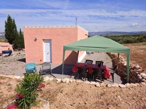 a table and chairs under a green tent at Maset Paradiso in Vanacloig +18 photos