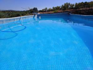 a large swimming pool with blue water at Maset Paradiso in Vanacloig
