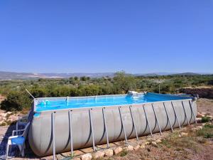 a large swimming pool sitting on top of a hill at Maset Paradiso in Vanacloig