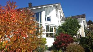 a white house with trees in front of it at Wildnisresidenz am Nationalpark in Lindberg