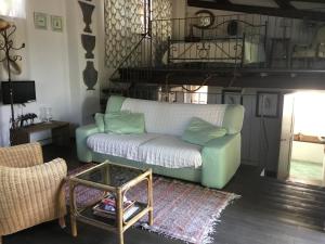 a living room with a couch and a table at Chalet fronte piscina in Zambra