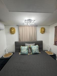 a bedroom with a large bed with two pillows at Csillagkapu Vendégház in Kápolnásnyék