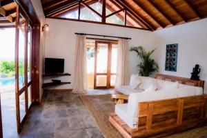 a living room with a white couch and a tv at Blue Beach Villa - Nilwella in Matara