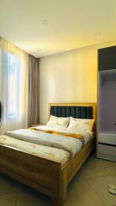 a large bed in a room with a window at AGASARO LUXURY Apartment in Kigali +34 photos