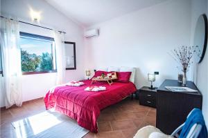 a bedroom with a red bed and a window at La Suara Manna - Happy Rentals in Telti