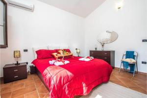 a bedroom with a red bed with a red blanket at La Suara Manna - Happy Rentals in Telti