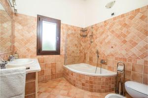 a bathroom with a tub and a sink and a toilet at La Suara Manna - Happy Rentals in Telti
