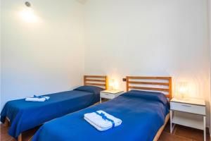 two beds in a room with blue sheets and towels at La Suara Manna - Happy Rentals in Telti +27 photos