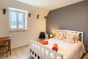 a bedroom with a bed and a window at Gite Le Ginestou in Almon-les-Junies