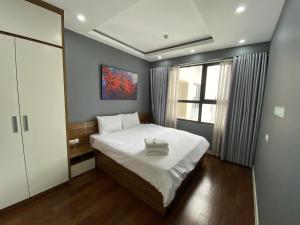 a small bedroom with a bed and a window at Vinhomes D'Capitale - Amee Apartment in Hanoi +36 photos