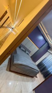 an attic room with a bed under a ceiling at Om Sai Ram Hotel in Rājūra