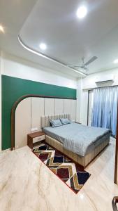 a bedroom with a bed and a rug at Om Sai Ram Hotel in Rājūra