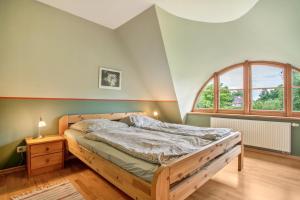 a bedroom with a bed and a large window at Alte Scheune in Putbus