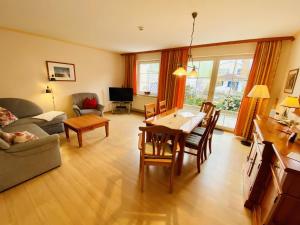 a living room with a table and a dining room at Ferienhaus Jan in Warnemünde