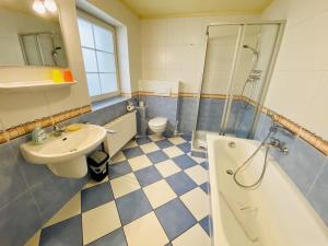 a bathroom with a sink and a shower and a toilet at Ferienhaus Adele in Warnemünde +17 photos