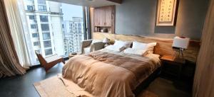 a bedroom with a large bed and a large window at 忘寂民宿 in Zhangjiajie +6 photos