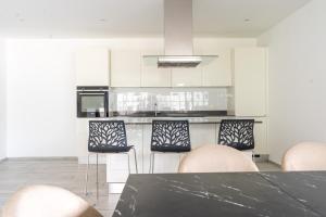 a kitchen with a table and chairs and a counter at Villa Sementina - Luxury Stay with Pool and Gym - 15 m to Lake Maggiore in Bellinzona