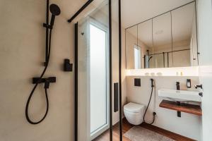 a bathroom with a shower and a toilet and a sink at Modern Seaside House in Pakoštane