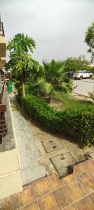 a street with trees and a parking lot with a car at krishna kunj stay in Mathura