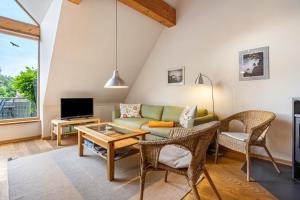 a living room with a couch and a tv at Alte Scheune in Putbus