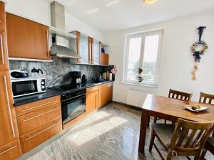 a kitchen with wooden cabinets and a wooden table at Marthes Seeblick in Warnemünde