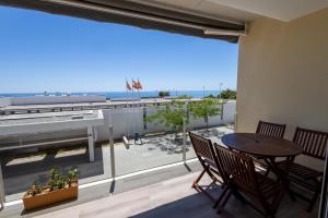 a balcony with a table and chairs and a view of the ocean at Suites At Sea II in Villajoyosa