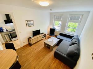a living room with a couch and a table at Kapitänshaus in Warnemünde +10 photos