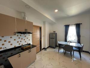a kitchen with a table and a dining room at Bristol Court in Kathmandu