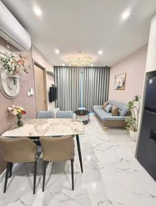 a living room with a table and chairs and a couch at Bristol Court in Kathmandu