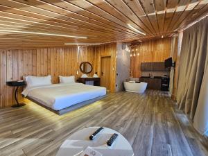 a bedroom with a bed and a tub in it at O Sommet in Zaarour +123 photos