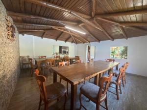 a dining room with wooden tables and chairs at Pensiunea Mary in Moieciu de Jos