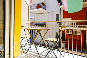 a table and chairs sitting on a balcony at Pole Pole - SOLE in Agropoli
