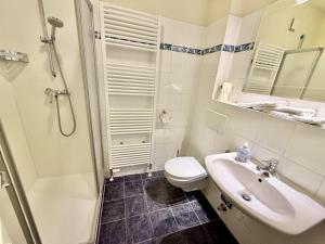 a bathroom with a toilet and a sink and a shower at WarneSonne in Warnemünde +11 photos