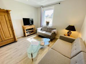 a living room with a couch and a coffee table at Ferienhaus Viewpoint in Warnemünde