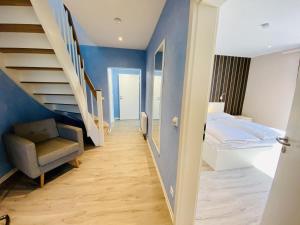 a room with a staircase and a bed and a chair at Ferienhaus Viewpoint in Warnemünde