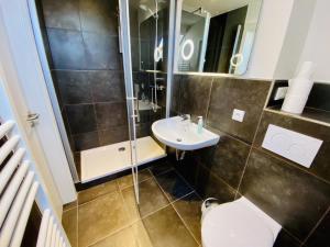 a bathroom with a shower and a toilet and a sink at Ferienhaus Viewpoint in Warnemünde +14 photos