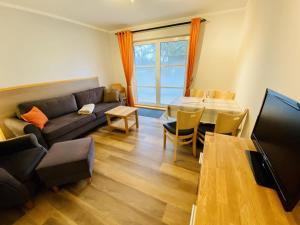 a living room with a couch and a table at Landhaus Immenbarg, Sonne in Warnemünde