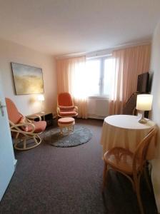 a room with a table and chairs and a window at Landhaus Martens in Bresewitz