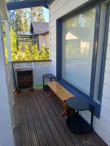 a screened porch with a bench and a window at Cozy Studio Järvenpää in Järvenpää +1 photo